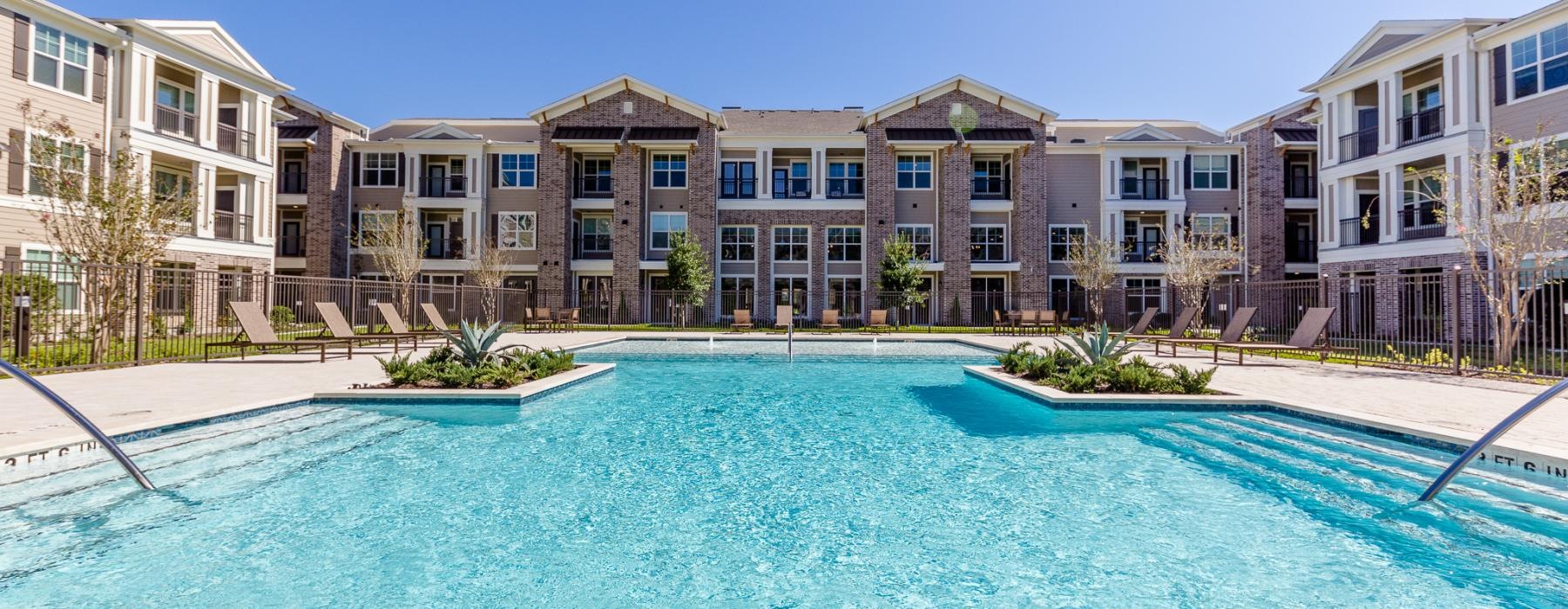 a large building with a pool in front of it