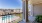 a balcony with a view of a the property and the pool