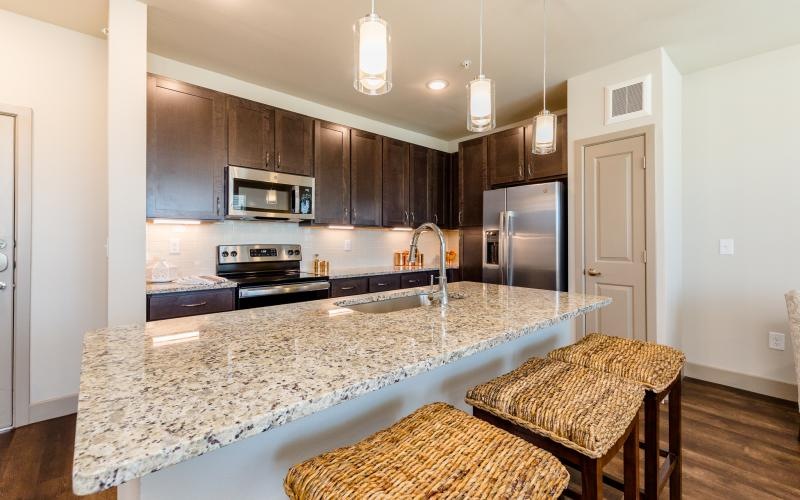 a kitchen with a marble island